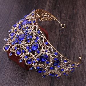 Close-up of golden Baroque bridal crown with deep blue crystals and rhinestones