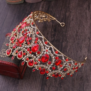 Close-up of luxury gold crown with ruby red crystals and sparkling rhinestones