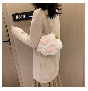 Close-up of cute 3D cat paw plush shoulder bag with golden metal chain strap
