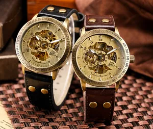 Detailed close-up of retro bronze mechanical watches with hollow dial and leather rivet strap