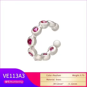 Detailed view of C-shaped brass ear cuff with pink cubic zirconia and rhodium plating