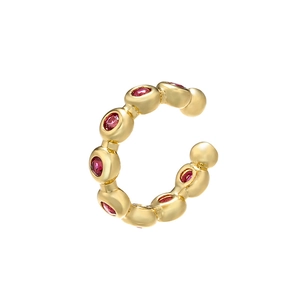Gold C-shaped ear cuff featuring multiple round red cubic zirconia stones in a minimalist style