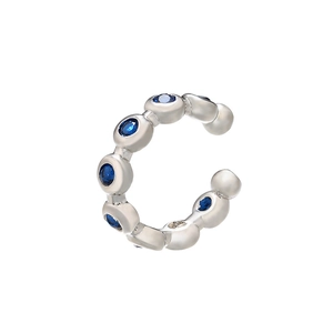 Detail of silver C-shape ear cuff featuring micro-pave blue cubic zirconia stones