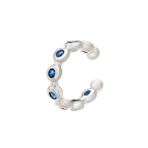 Macro shot of silver ear cuff accessory featuring micro-pave blue cubic zirconia stones