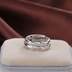 Silver woven wave ring with sparkling crystal accents in a minimalist open design