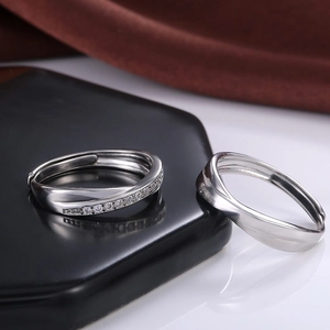 Minimalist silver wave rings for couples featuring a cross design and sparkling crystal inlay