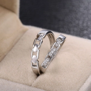Silver couples ring set featuring interlocking chain design with pavé cubic zirconia