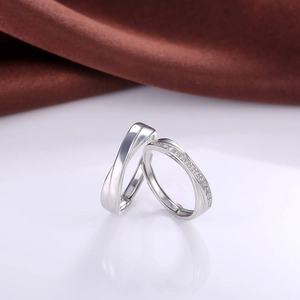 Detailed view of silver plated couple rings featuring twisted band and inlaid zircon stones