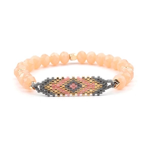 Detail of Miyuki evil eye beaded bracelet with faceted beads and geometric weaving