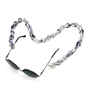 Black round sunglasses with thick marble pattern acrylic eyewear chain strap on white background