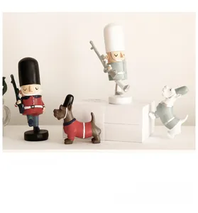 Detailed view of matte Nutcracker soldier figures and Scottish Terrier dog ornaments