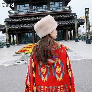 Detail of khaki faux rabbit fur winter hat paired with an ethnic print hooded shawl