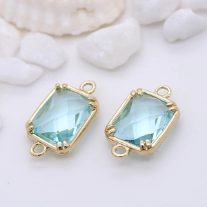 Close-up of dual-loop 14k gold-plated light blue faceted glass stone jewelry connectors