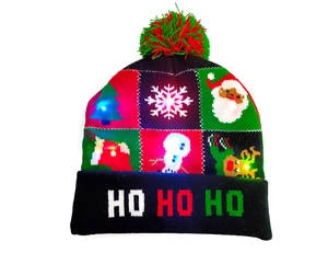 Detail of festive LED knitted Christmas hat featuring glowing lights and colorful pompoms