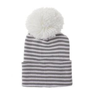 Close-up detail of striped baby knitted beanie with a soft white fluffy pom-pom.