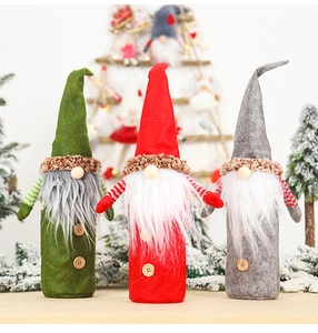Detailed view of three gnome wine bottle covers in red, green and grey festive designs
