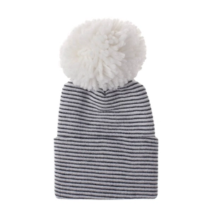 Detailed view of striped knit baby hat featuring a large white faux fur pompom on top