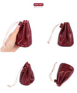Macro view of a wine red vintage leather coin purse with drawstring and soft texture