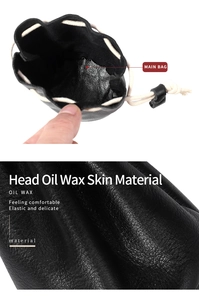 Detailed close-up of premium black oil wax leather texture on a drawstring pouch