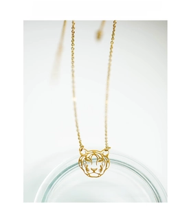Detailed close-up of hollow tiger head pendant in 18K gold-plated stainless steel
