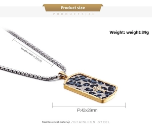 Detail of gold stainless steel rectangular pendant with leopard print and crystal cross