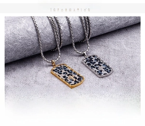 Detail of stainless steel dog tag pendants with leopard pattern and cross accents
