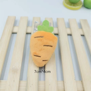 Macro detail of plush carrot brooch showing orange texture and 7x4cm size dimensions