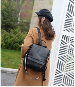 Fashionable black leather backpack for women featuring stylish striped shoulder straps