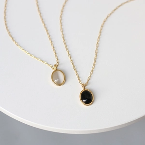 Vintage 18K gold plated titanium necklace with oval black and white cat eye stone pendants