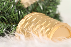 Detail of the woven golden base for a Christmas tree set on soft white faux fur