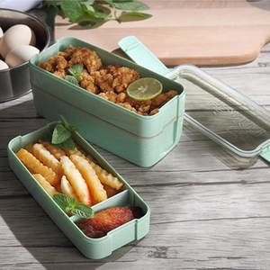 Three-layer eco-friendly wheat straw bento box for students with green finish on wood table