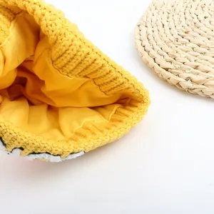 Close-up of bright yellow knitted baby hat featuring thick knit texture and warm cotton lining