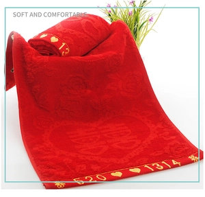 Close-up of red wedding towel with 520 1314 embroidery and embossed rose pattern