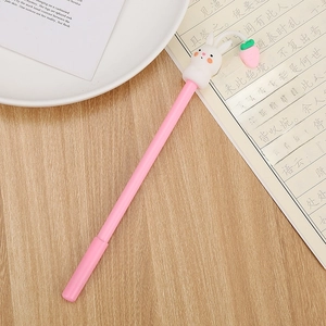Cute pink rabbit stationery gel pen with silicone carrot accessory on a wooden desk