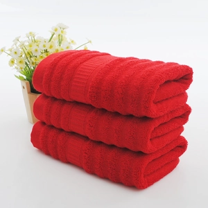 Three-piece stack of thick red cotton wedding towels with wave pattern and bamboo fiber texture
