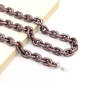 Detail of matte purple acrylic eyewear chain with adjustable silicone loops on a book