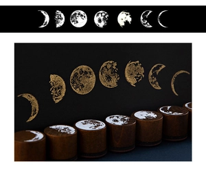 Detail showing moon phase wooden stamps with golden ink lunar prints on black paper