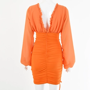 Detail view showing orange dress back with invisible zipper and ruffles on V-neckline