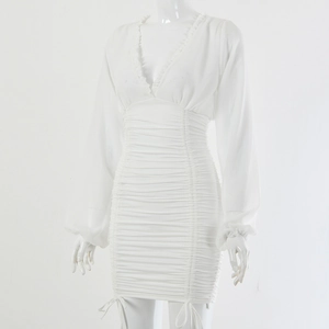 Detail of white deep V-neck dress featuring ruffle trim and ruched drawstring design