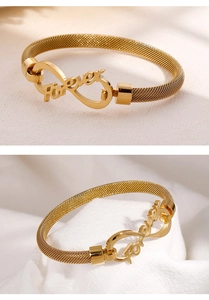 Close-up of golden mesh bracelet with forever word and infinity symbol detail
