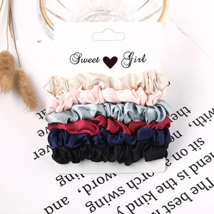Detailed set of six satin scrunchies in varied colors on a Sweet Girl card