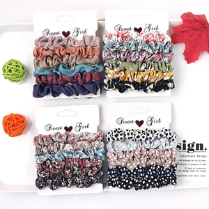 Close-up of assorted fabric scrunchies sets with polka dots and floral patterns on cards