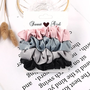 Detail view of 4-pack satin scrunchies in candy colors on a Sweet Girl display card
