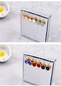 Macro detail of multi-colored round zircon earrings in gold-plated stainless steel bezels