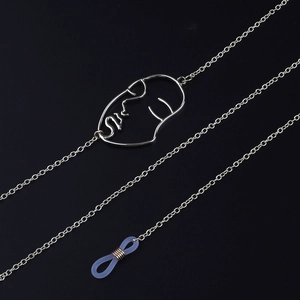 Silver eyewear chain featuring a minimalist face profile pendant on a sleek metal link