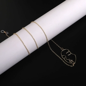 Golden eyewear chain with minimalist abstract face pendant and anti-slip silicone loops