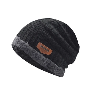 Classic black knitted winter beanie for men and women with warm thick grey faux fur lining
