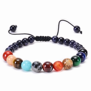 Detail of hand-woven solar system bracelet with natural stones and adjustable cord