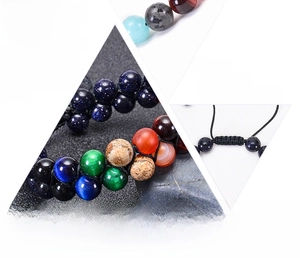 Detail of handmade natural stone solar system beads with adjustable braided cord