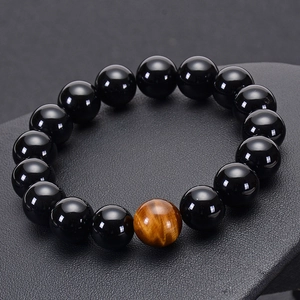 Polished natural black agate beaded bracelet with yellow tiger eye stone on dark base